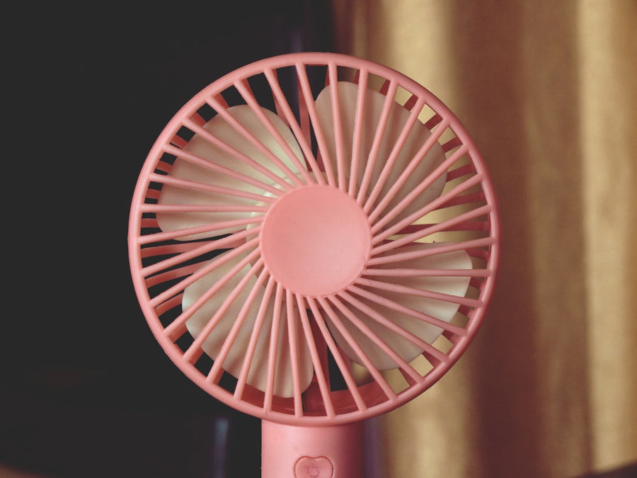 Handheld portable personal fan held up close