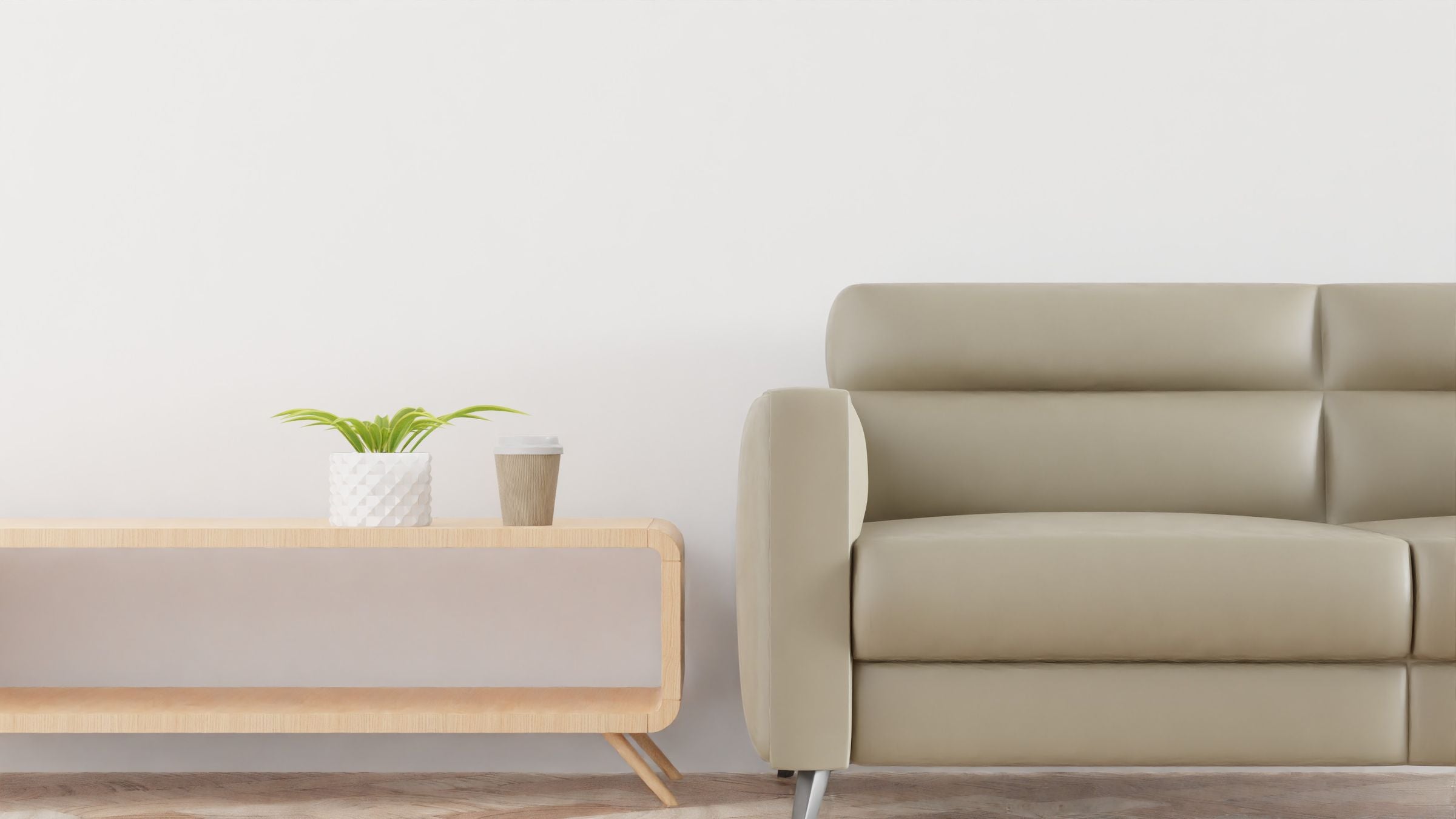 Modern living room with a beige sofa, plant, and warm minimalist decor