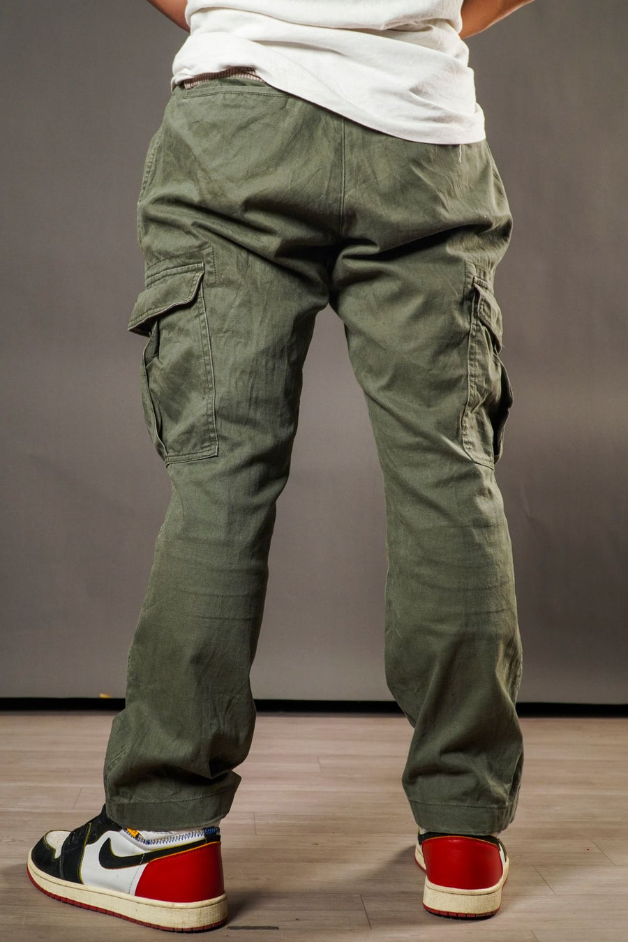 Person wearing baggy oversized cargo parachute pants and sneakers