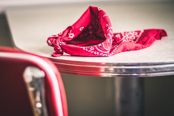 Red paisley bandana resting on a diner table