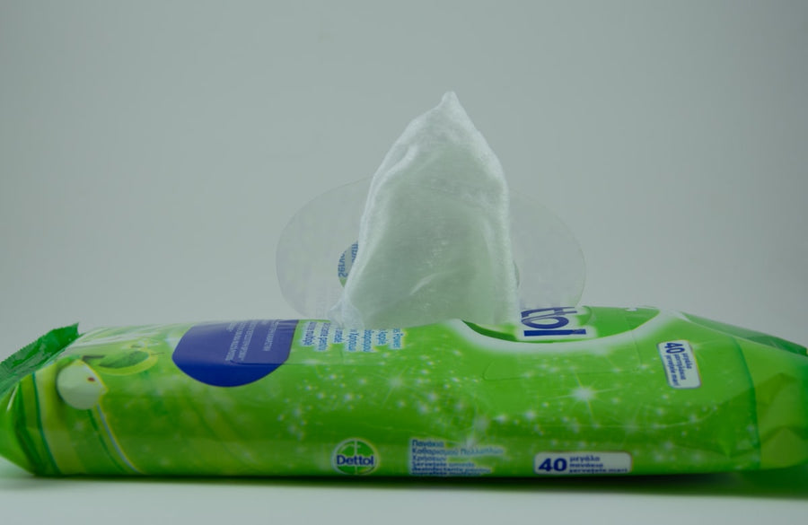 Pack of wet wipes with a wipe pulled out of the resealable opening