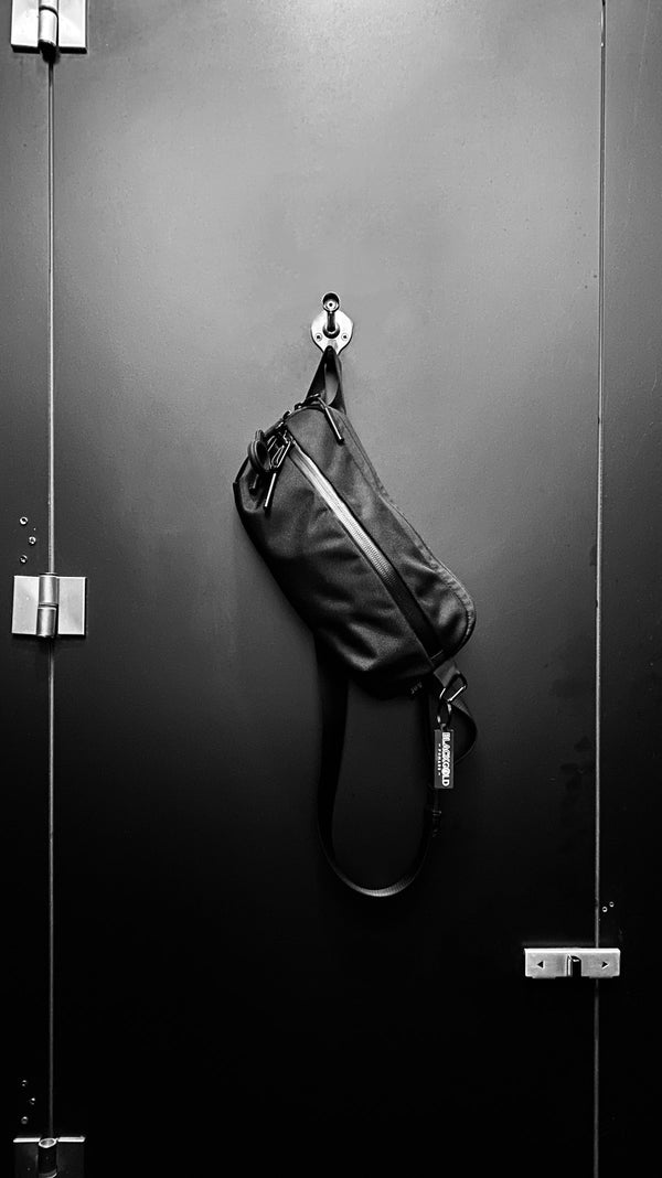 Black leather crossbody sling bag with adjustable strap