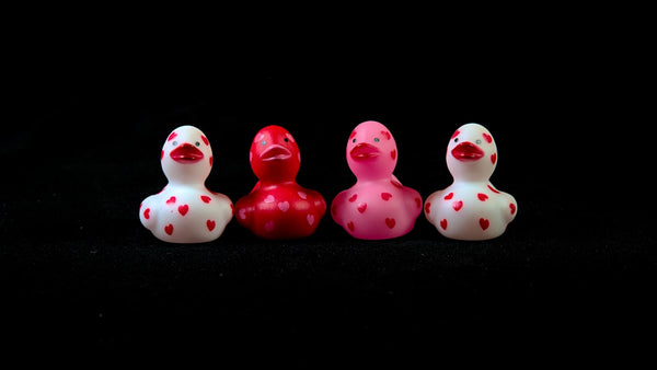 Group of tiny rubber ducks lined up in a row