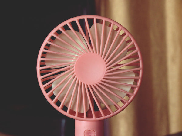 Handheld portable personal fan held up close